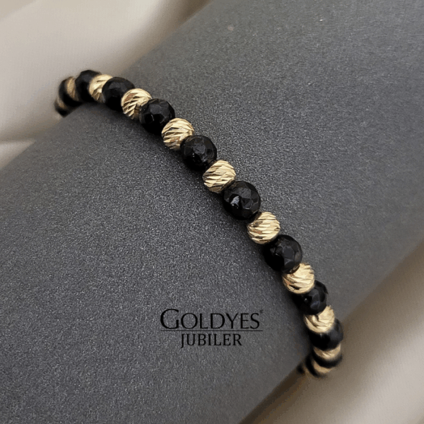złota bransoletka na czarnym sznureczku z diamentowanymi kulkami próba złota 585
