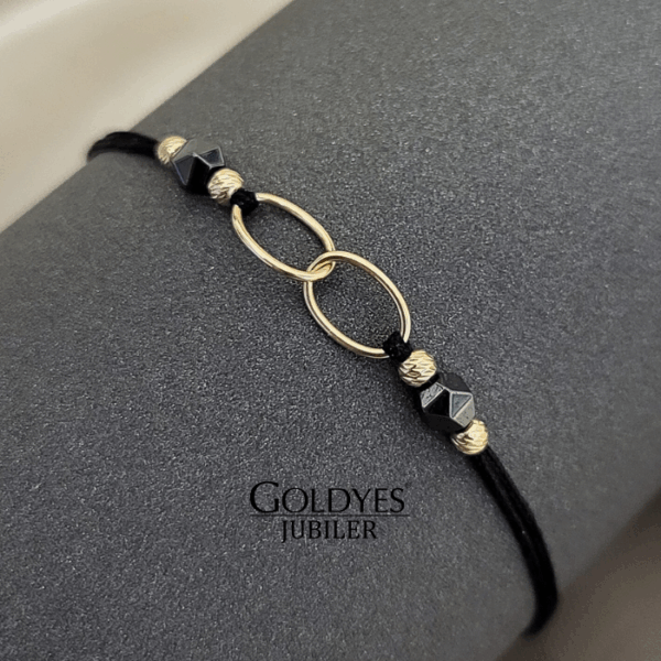 złota bransoletka na czarnym sznureczku z diamentowanymi kulkami próba złota 585