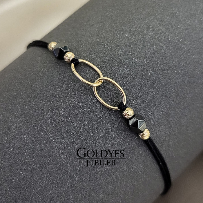 złota bransoletka na czarnym sznureczku z diamentowanymi kulkami próba złota 585