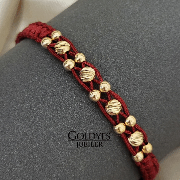 złota bransoletka na czarnym sznureczku z diamentowanymi kulkami próba złota 585