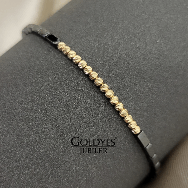 złota bransoletka na czarnym sznureczku z diamentowanymi kulkami próba złota 585