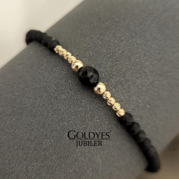 złota bransoletka na czarnym sznureczku z diamentowanymi kulkami próba złota 585
