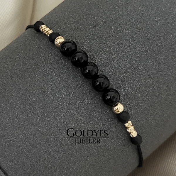 złota bransoletka na czarnym sznureczku z diamentowanymi kulkami próba złota 585