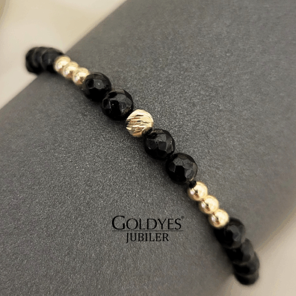 złota bransoletka na czarnym sznureczku z diamentowanymi kulkami próba złota 585