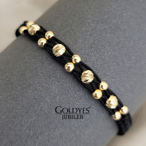 złota bransoletka na czarnym sznureczku z diamentowanymi kulkami próba złota 585