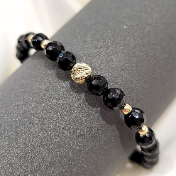 złota bransoletka męska na czarnym sznurku z diamentowanymi kulkami i czarnym onyksem próba złota 585